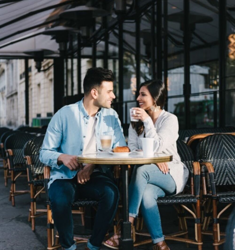 man and a woman on a date at a cafe