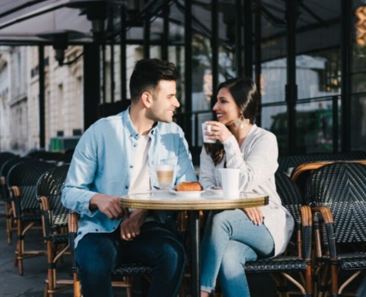 man and a woman on a date at a cafe